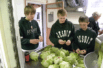Strake Jesuit tennis team making salad with ingredients they brought