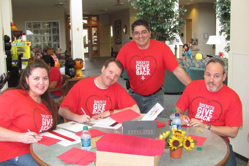 Houston Rockets volunteers addressing holiday cards, 2011